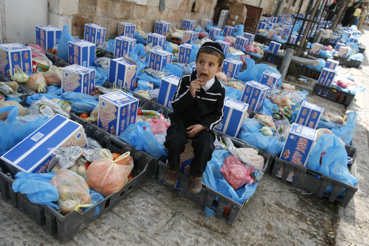 A little boy rest on a matzos box
